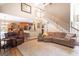 Open concept living room with a staircase, comfortable seating, and wood floors at 150 Murphy Creek Ln, Fayetteville, GA 30215