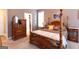 Comfortable main bedroom features a four-poster bed at 150 Murphy Creek Ln, Fayetteville, GA 30215