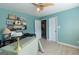 The office features carpet flooring, aqua-painted walls, and storage shelves for optimal organization at 150 Murphy Creek Ln, Fayetteville, GA 30215