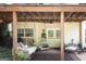 Charming covered patio with a swing bed, ceiling fan, and double doors leading to the house at 150 Murphy Creek Ln, Fayetteville, GA 30215