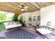 Covered patio featuring swing, ceiling fan, seating and black and pink rug at 150 Murphy Creek Ln, Fayetteville, GA 30215