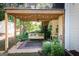 Inviting covered patio with a swing bed, string lights, and lush greenery for relaxing outdoor living at 150 Murphy Creek Ln, Fayetteville, GA 30215