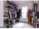 Spacious walk-in closet with built-in shelving and racks for organized clothing storage at 150 Murphy Creek Ln, Fayetteville, GA 30215