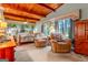 Inviting bedroom with wood beam ceiling, comfortable armchairs, and large windows offering scenic views and creating a relaxing retreat at 1813 Freeman Rd, Jonesboro, GA 30236