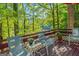Relaxing deck area overlooking a lake and lush trees, with comfortable seating and decor at 1813 Freeman Rd, Jonesboro, GA 30236