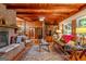 Spacious living room with hardwood floors, wood paneling, brick fireplace, and large windows offering natural light and a cozy atmosphere at 1813 Freeman Rd, Jonesboro, GA 30236