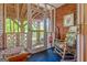 Cozy sunroom with brick walls, screened windows offering natural light, and a rocking chair at 1813 Freeman Rd, Jonesboro, GA 30236