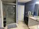 Bathroom with a spacious glass enclosed shower and ample vanity storage at 565 Miles Ct, Locust Grove, GA 30248