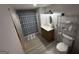 Bathroom view with wood-style floors, and a shower/tub combo with a blue and gray striped curtain at 565 Miles Ct, Locust Grove, GA 30248