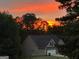 Charming home exterior silhouetted by a brilliant sunset at 565 Miles Ct, Locust Grove, GA 30248