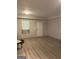 Living room showcasing wood floors, window with A/C, and freshly painted walls at 565 Miles Ct, Locust Grove, GA 30248