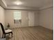 Living room featuring wood-look floors, a window with an A/C, and a door at 565 Miles Ct, Locust Grove, GA 30248