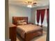 Bedroom with carpet, ceiling fan, and window with red curtains at 565 Miles Ct, Locust Grove, GA 30248