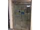 Enclosed shower stall with gray tiling and updated fixtures at 565 Miles Ct, Locust Grove, GA 30248