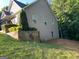 Exterior side view of home featuring landscaped retaining wall and vinyl siding at 565 Miles Ct, Locust Grove, GA 30248
