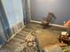 Bright sitting area with a rocking chair and patterned rug, perfect for relaxation and enjoying natural light at 565 Miles Ct, Locust Grove, GA 30248