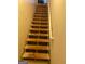 Basement stairway featuring wooden treads and a white handrail at 565 Miles Ct, Locust Grove, GA 30248