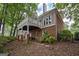 Exterior view of brick home featuring a covered porch and access to the backyard at 5028 Chapel Lake Cir, Douglasville, GA 30135