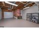 Unfinished basement featuring exposed wood framing, garage door, and metal shelving at 5028 Chapel Lake Cir, Douglasville, GA 30135