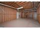Unfinished basement featuring exposed wood framing and painted floor with door access at 5028 Chapel Lake Cir, Douglasville, GA 30135