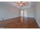 Large bedroom with hardwood flooring, tray ceiling, ceiling fan, and neutral walls at 5028 Chapel Lake Cir, Douglasville, GA 30135