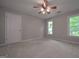Bedroom with carpet, a window with a view, and a ceiling fan at 5028 Chapel Lake Cir, Douglasville, GA 30135