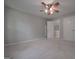 Carpeted bedroom with a ceiling fan and access to multiple closets and interior doors at 5028 Chapel Lake Cir, Douglasville, GA 30135