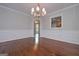 Dining room with hardwood floors, wainscoting, chandelier lighting, and doorway to another room at 5028 Chapel Lake Cir, Douglasville, GA 30135