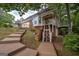 Back exterior view of home with wooden staircase, deck, and fenced yard at 5028 Chapel Lake Cir, Douglasville, GA 30135