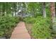 Exterior view of home with wooden staircase and lush landscaping at 5028 Chapel Lake Cir, Douglasville, GA 30135