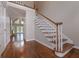 Bright foyer with hardwood floors, a staircase, and views into a spacious living area at 5028 Chapel Lake Cir, Douglasville, GA 30135
