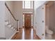 Welcoming foyer with hardwood floors, staircase, and access to a powder room, showcasing natural light at 5028 Chapel Lake Cir, Douglasville, GA 30135