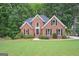 Charming brick home with a well-manicured lawn and mature trees offering great curb appeal at 5028 Chapel Lake Cir, Douglasville, GA 30135