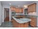 Traditional kitchen featuring wood cabinets, a center island with cooktop, and a built-in stainless steel microwave at 5028 Chapel Lake Cir, Douglasville, GA 30135