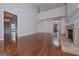 Open-concept living room with hardwood floors, a stone fireplace, and views of the foyer at 5028 Chapel Lake Cir, Douglasville, GA 30135