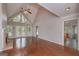 Spacious living room featuring a vaulted ceiling, fireplace, and access to an outdoor deck at 5028 Chapel Lake Cir, Douglasville, GA 30135