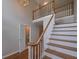 Elegant staircase with wood railing leads to a second story landing area at 5028 Chapel Lake Cir, Douglasville, GA 30135