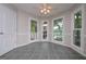Bright sunroom with tile floor, multiple windows, and a door that opens to the outside at 5028 Chapel Lake Cir, Douglasville, GA 30135