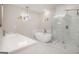Elegant bathroom with a standalone tub, glass shower, and marble finishes, creating a spa-like retreat at 7428 Mockingbird Trl, Riverdale, GA 30274