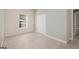Bright bedroom with natural light, light colored walls, and closet storage space at 7428 Mockingbird Trl, Riverdale, GA 30274