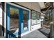 Inviting front porch featuring bright blue double doors and stylish lighting, adding curb appeal and charm at 7428 Mockingbird Trl, Riverdale, GA 30274