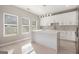 Modern kitchen with white cabinets, marble countertops, and stainless steel appliances, offering both style and function at 7428 Mockingbird Trl, Riverdale, GA 30274