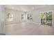 Bright, spacious living room with large windows and sliding glass doors to the porch, allowing for ample natural light at 7428 Mockingbird Trl, Riverdale, GA 30274