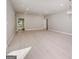 Spacious living room with light wood floors, recessed lighting, and elegant chandelier, perfect for entertaining at 7428 Mockingbird Trl, Riverdale, GA 30274