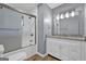 Modern bathroom features a glass-enclosed shower, white vanity with granite top, and wood-look tile flooring at 2315 Shancey Ln, South Fulton, GA 30349