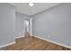 A bright bedroom with beautiful hardwood floors, light grey walls, and a glimpse into the bathroom at 2315 Shancey Ln, South Fulton, GA 30349