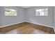Bright bedroom features hardwood floors and natural light from two windows at 2315 Shancey Ln, South Fulton, GA 30349