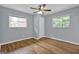 A comfortable bedroom with hardwood floors, a ceiling fan, and natural light from two windows at 2315 Shancey Ln, South Fulton, GA 30349