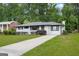 Charming white brick home with a well-maintained lawn, mature trees, and a paved driveway at 2315 Shancey Ln, South Fulton, GA 30349