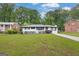 Well-maintained front yard with a white brick house, trimmed shrubs, and a concrete driveway at 2315 Shancey Ln, South Fulton, GA 30349